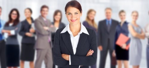 image of woman standing in front of large group of people